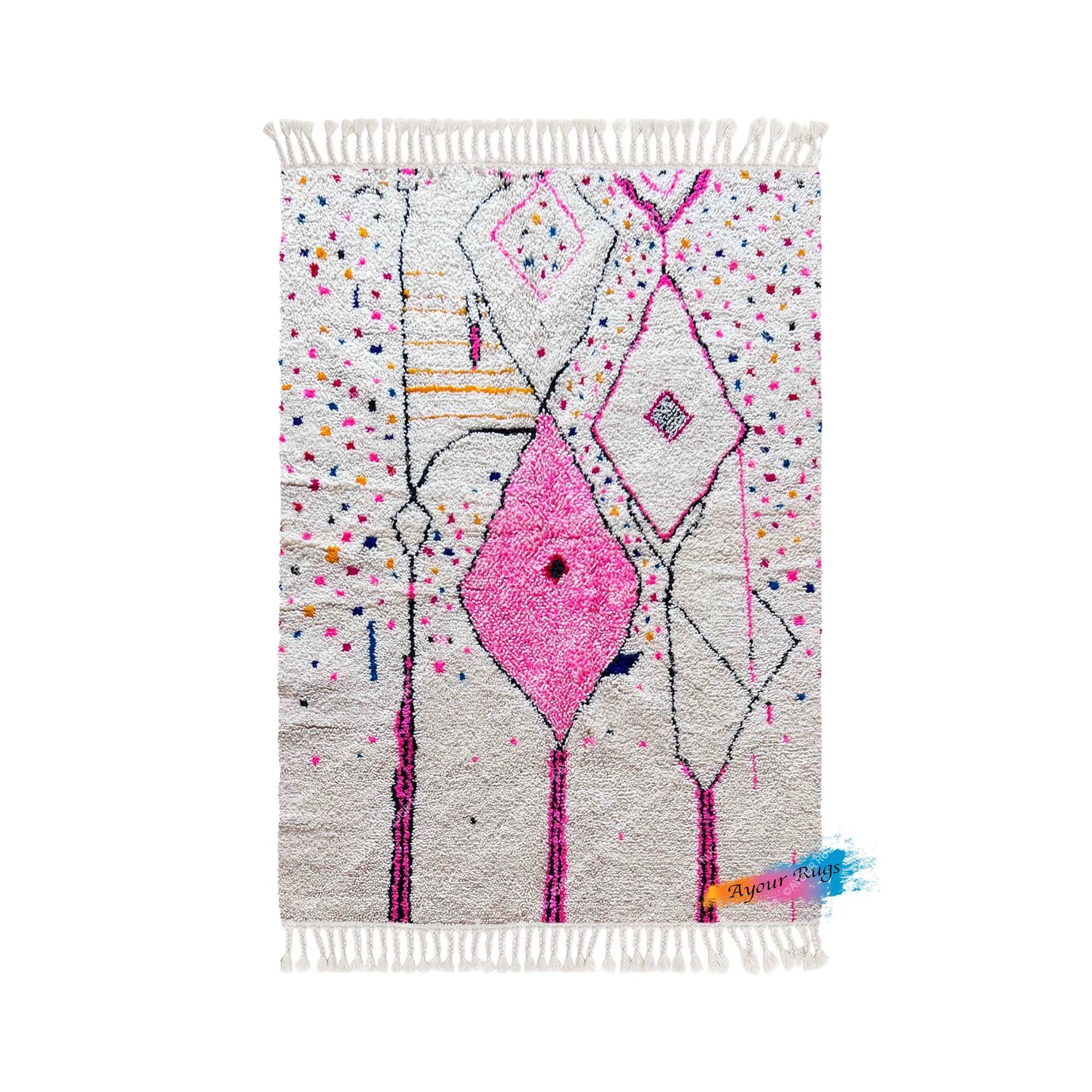 a vibrant, colorful rug with a geometric pattern and a pink diamond motif.