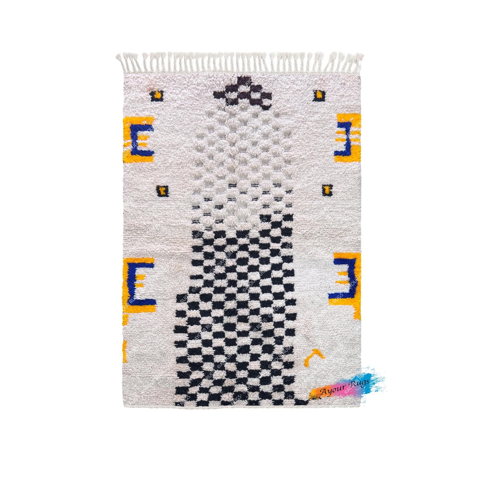 a colorful rug with a geometric pattern of squares and rectangles in various shades of gray, black, and yellow.
